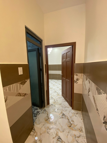 Nhà phố Quận 6 Nhà phố thiết kế 1 trệt, 2 lầu và sân thượng, cửa hướng Nam mát mẻ.